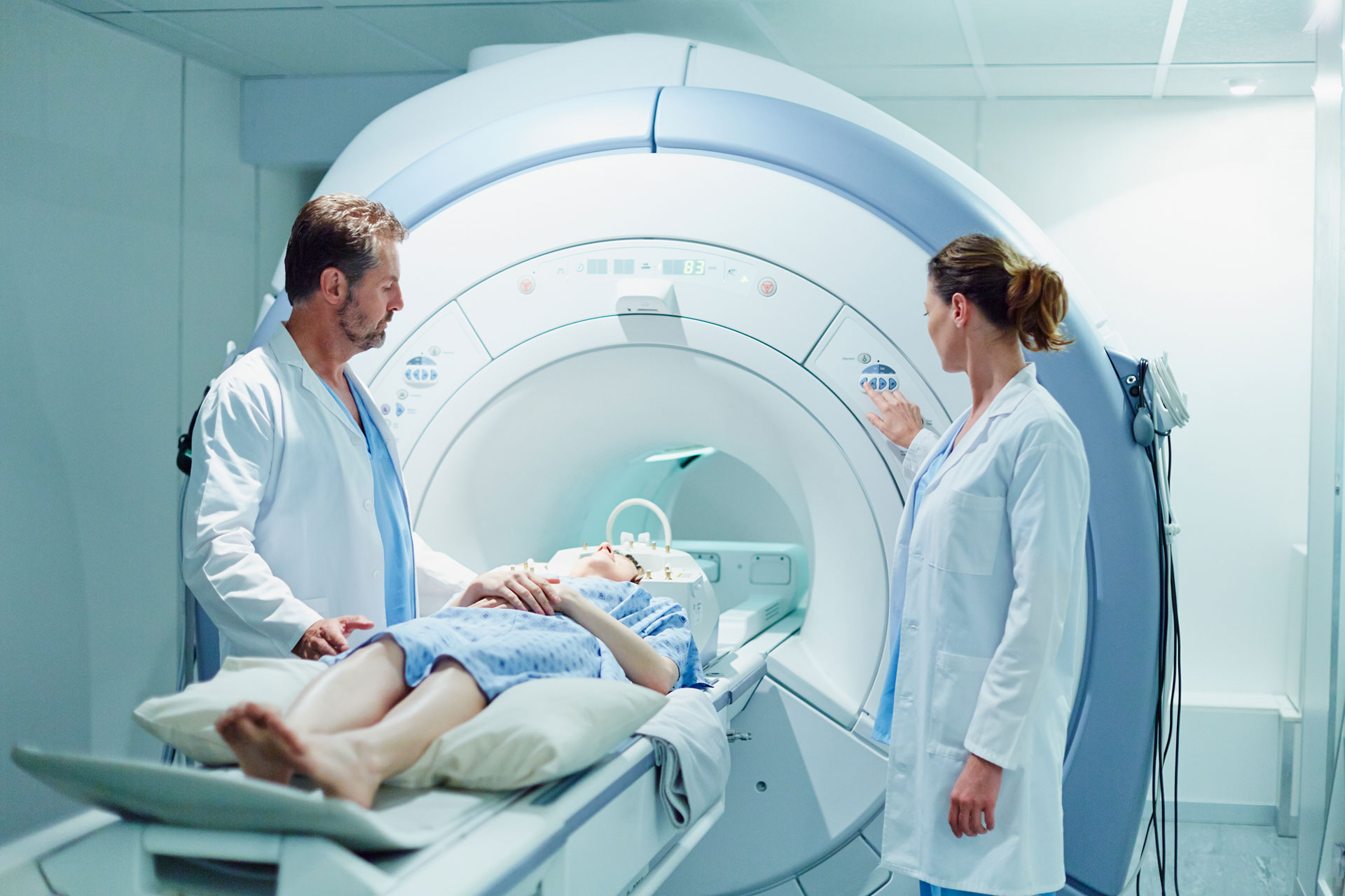 Two Doctors with patient in MRI room