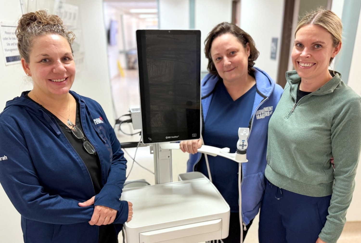 3 staff members stand beside new BDSite-Rite 9 Ultrasound Tech equipment