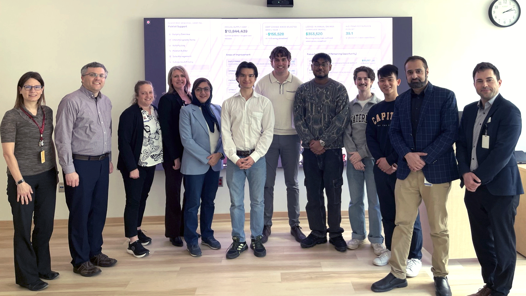 Professor Houra Mahmoudzadeh and her student team stand with staff from Purchasing Department and Decision Support Department teams.