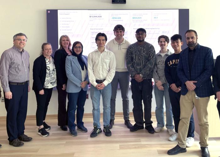 Professor Houra Mahmoudzadeh and her student team stand with staff from Purchasing Department and Decision Support Department teams.